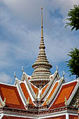 Bangkok Wat Arun - Detail of the entrance of the ubosot. The spire is decorated with polychromatic mosaic flowers made from ceramic chips. 